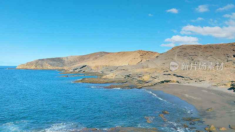 Aerial view of the beach "Playa Escondida" and the natural reserve of "Montaña Pelada" in Tenerife (Canary Islands). Drone shot